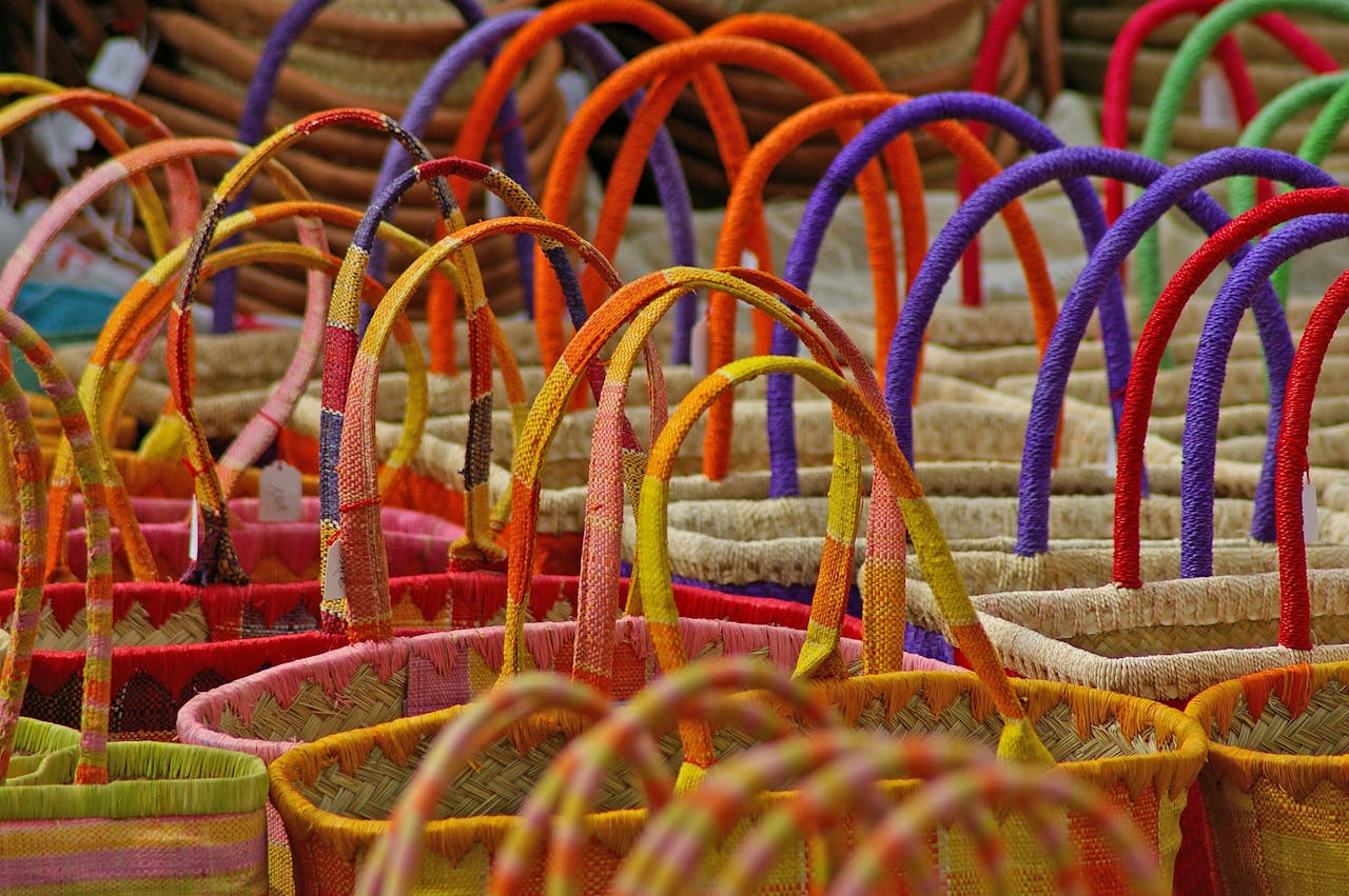 gallery-6 Close-up of colorful wicker baskets with handles at a market stall. Ideal for decor themes.