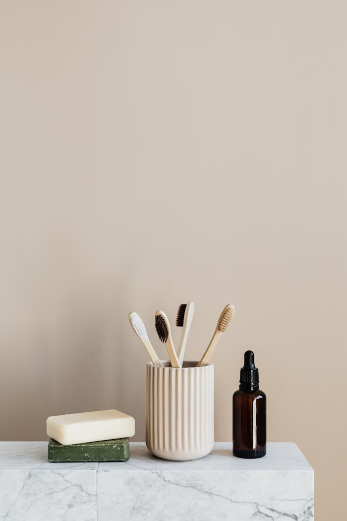 about-01 Minimalist eco-friendly bathroom essentials with bamboo toothbrushes and organic soap on marble.